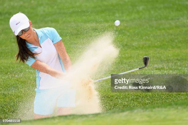 Sophie Lamb of the Great Britain and Ireland team plays a shot from a bunker on the 15th hole in her match with Olivia Mehaffey against Jennifer...