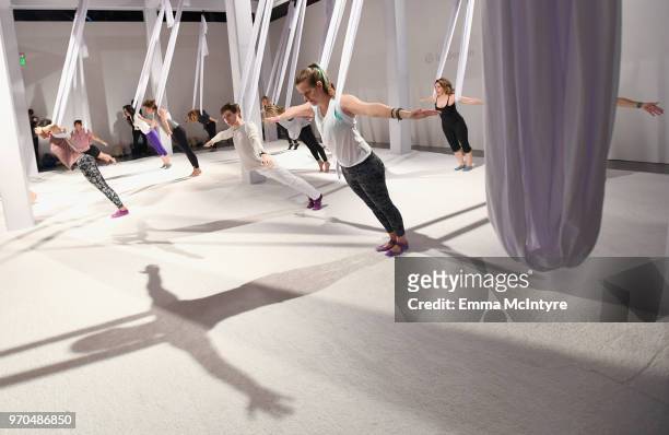 Guests attend aerial yoga at the In goop Health Summit at 3Labs on June 9, 2018 in Culver City, California.