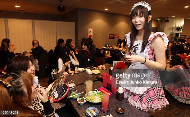 Male waiter, wearing women's clothes, serves customers at New Type cafe on February 25, 2010 in Tokyo, Japan. Dressing up in female animation...