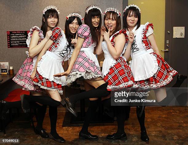 Male waiters, wearing women's clothes, pose for photographs at New Type cafe on February 25, 2010 in Tokyo, Japan. Dressing up in female animation...