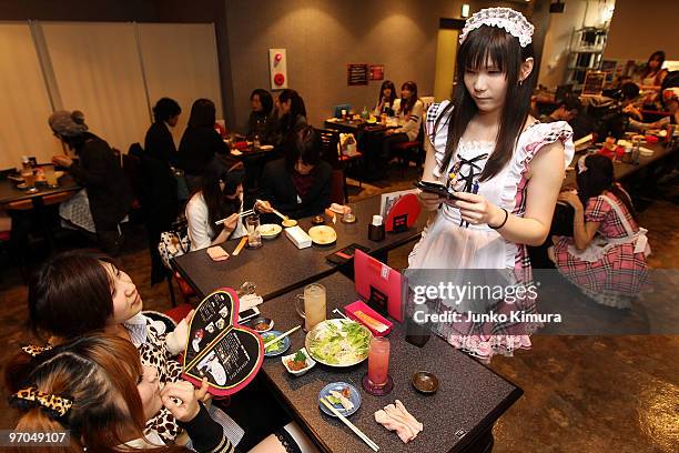 Male waiter, wearing women's clothes, serves customers at New Type cafe on February 25, 2010 in Tokyo, Japan. Dressing up in female animation...