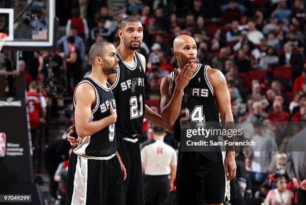 Tony Parker, Tim Duncan and Richard Jefferson of the San Antonio Spurs huddle on the court during the game against the Portland Trail Blazers at The...