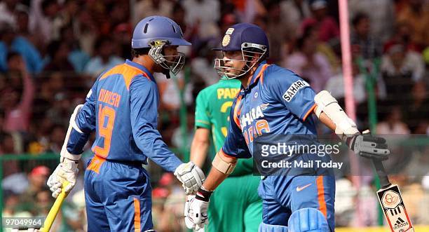 Sachin Tendulkar and Dinesh Karthik at the Gwalior ODI against South Africa in Gwalior on Wednesday, February 24, 2010.