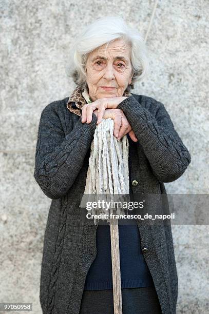 solitude - senior woman and mop - terza età stock pictures, royalty-free photos & images