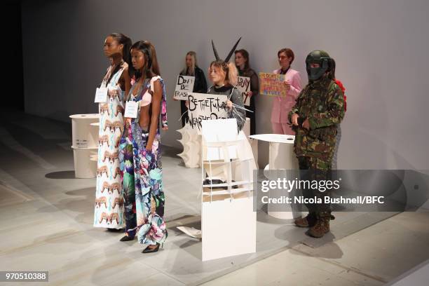 Models pose during the VIN + OMI press launch at London Fashion Week Men's June 2018 at 180 The Strand on June 9, 2018 in London, England.