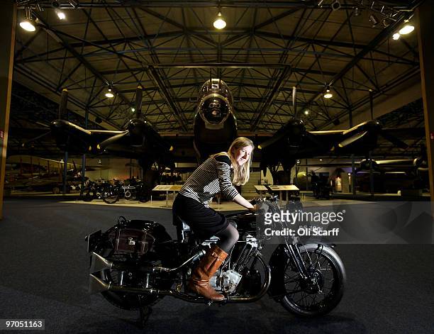 An employee of Bonhams auction house sits on a Brough Superior 1931 SS100 in the RAF Museum ahead of their sale of 100 pre-1950's motorcycles on...
