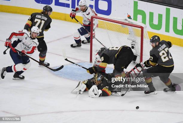 Marc-Andre Fleury of the Vegas Golden Knights makes a diving save on a shot by Jakub Vrana of the Washington Capitals as Nate Schmidt and Shea...