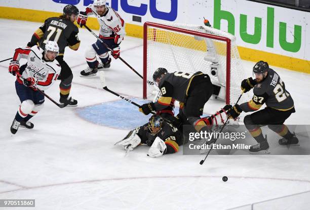 Marc-Andre Fleury of the Vegas Golden Knights makes a diving save on a shot by Jakub Vrana of the Washington Capitals as Nate Schmidt and Shea...