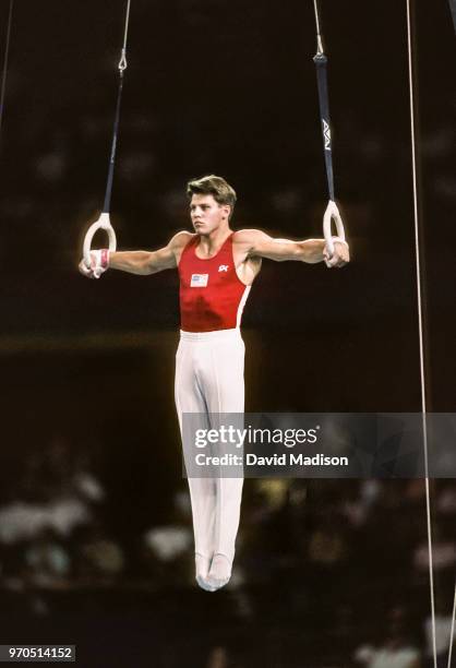 Chris Waller of the United States performs an Iron Cross on the still rings during the gymnastics competition of the 1990 Goodwill Games held from...