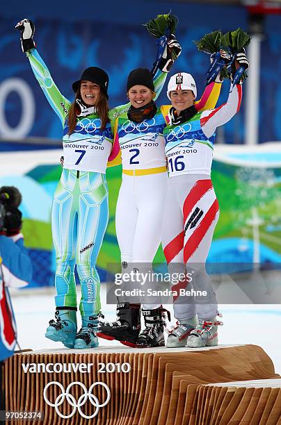 Tina Maze of Slovenia celebrates winning the silver medal, Viktoria Rebensburg of Germany gold and Elisabeth Goergl of Austria bronze during the...