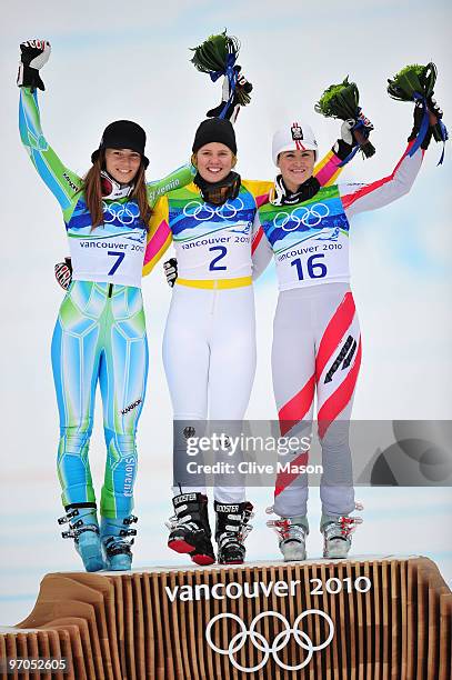 Tina Maze of Slovenia celebrates winning the silver medal, Viktoria Rebensburg of Germany gold and Elisabeth Goergl of Austria bronze during the...