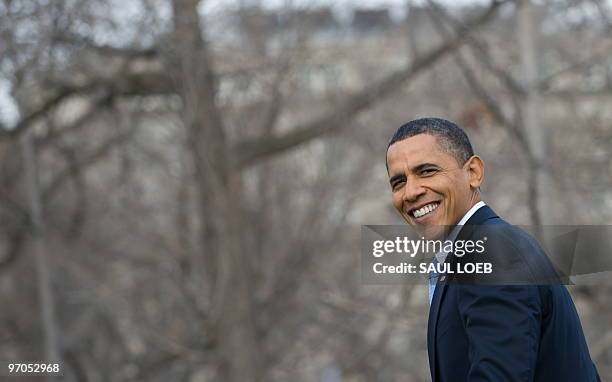 President Barack Obama smiles as he walks to Blair House, across the street from the White House, in Washington, DC, February 25 for the afternoon...