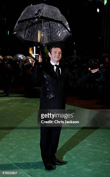 Actor Michael Sheen jokes about the weather as he attends the Royal World Premiere of "Alice in Wonderland" at the Odeon Leicester Square on February...