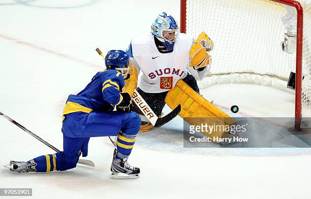 Noora Raty of Finland saves the shot from Maria Rooth of Sweden during the ice hockey women's bronze medal game between Finland and Sweden on day 14...