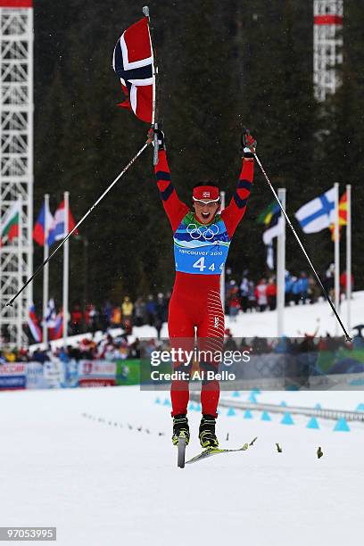 Marit Bjoergen of Norway jumps as she crosses the line after Norway won the gold medal during the Ladies' Cross Country 4x5 km Relay on day 14 of the...