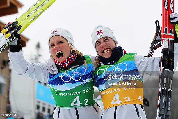 Therese Johaug of Norway and Kristin Stoermer Steira celebrate winning the gold medal during the Ladies' Cross Country 4x5 km Relay on day 14 of the...