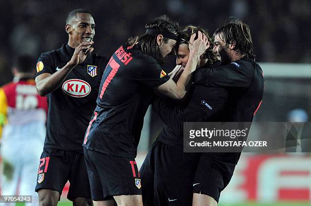 Diego Forlan of Atletico Madrid celebrates with teammates after scoring against Galatasaray during their UEFA Europa League football match at Ali...