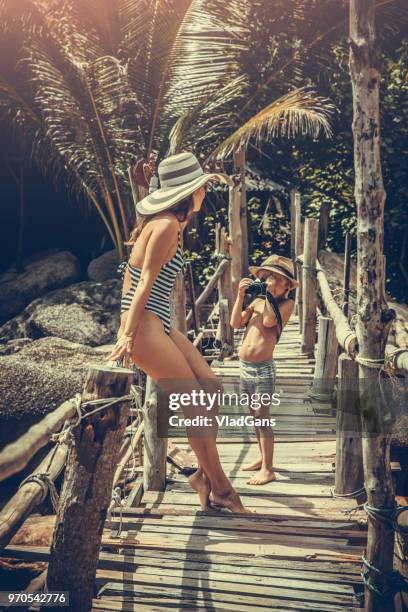 kid taking photo of his mother - woman long dress beach stock pictures, royalty-free photos & images