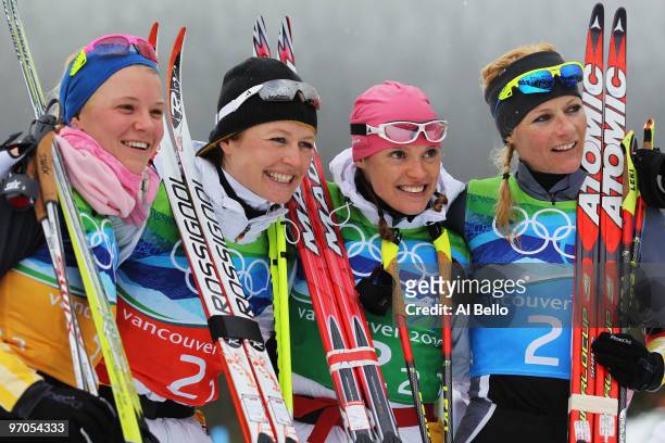 Miriam Gossner, Katrin Zeller, Evi Sachenbacher-Stehle and Claudia Nystad of Germany celebrate winning the silver medal during the Ladies' Cross...