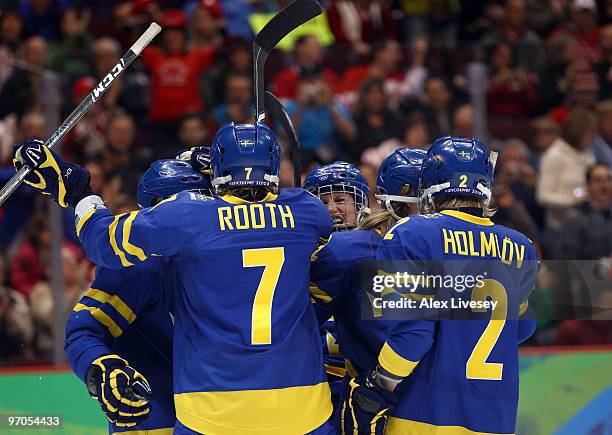 Maria Rooth of Sweden celebrates with teammates after scoring a goal during the ice hockey women's bronze medal game between Finland and Sweden on...