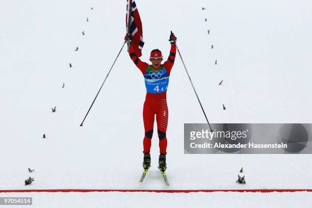 Marit Bjoergen of Norway jumps as she crosses the line after Norway won the gold medal during the Ladies' Cross Country 4x5 km Relay on day 14 of the...