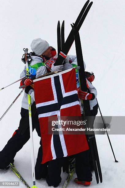 Vibeke W Skofterud, Kristin Stoermer Steira, Marit Bjoergen and Therese Johaug of Norway celebrate after winning the gold medal during the Ladies'...