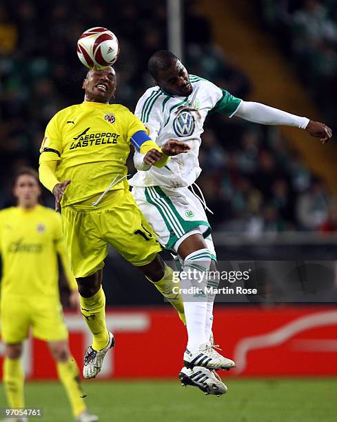 Grafite of Wolfsburg and Marcos Senna of Villareal head for the ball during the UEFA Europa League knock-out round, second leg match between VfL...