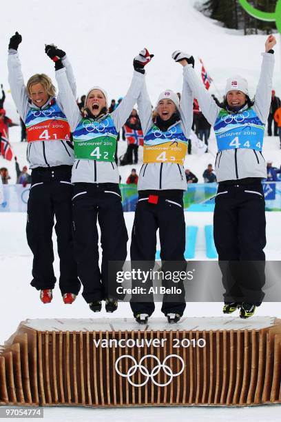Vibeke W Skofterud, Therese Johaug, Kristin Stoermer Steira and Marit Bjoergen of Norway celebrate after winning the gold medal during the Ladies'...