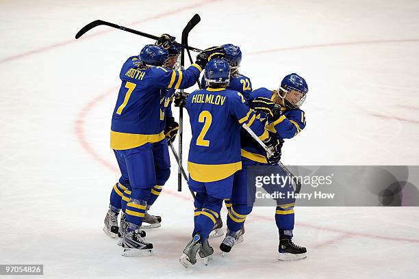 Maria Rooth of Sweden celebrates with teammates after scoring a goal during the ice hockey women's bronze medal game between Finland and Sweden on...