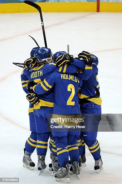 Maria Rooth of Sweden celebrates with teammates after scoring a goal during the ice hockey women's bronze medal game between Finland and Sweden on...