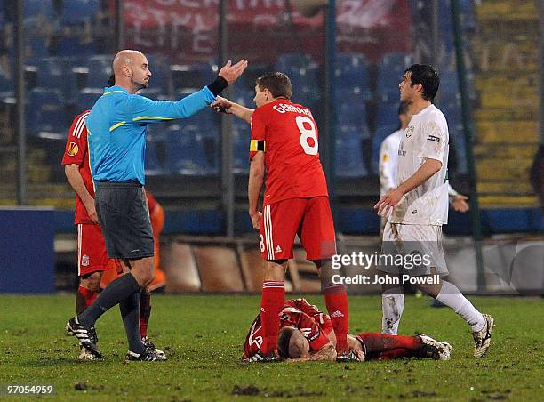 Steven Gerrard reacts after Martin Skrtel goes down injured during the UEFA Europa League knock-out round, second leg match between FC Unirea...