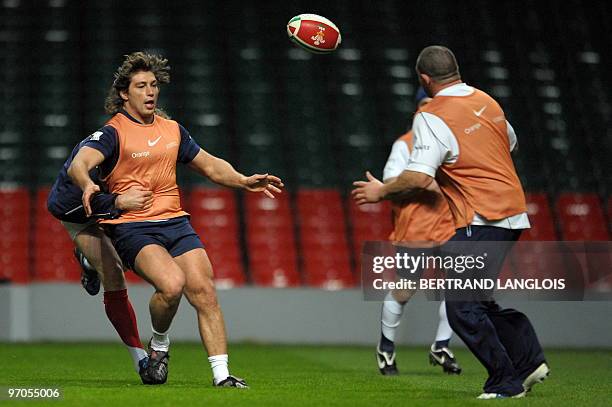 French rugby union national team's hooker Dimitri Szarzewski makes a pass to prop Clement Baiocco during a training session with teammates at the...