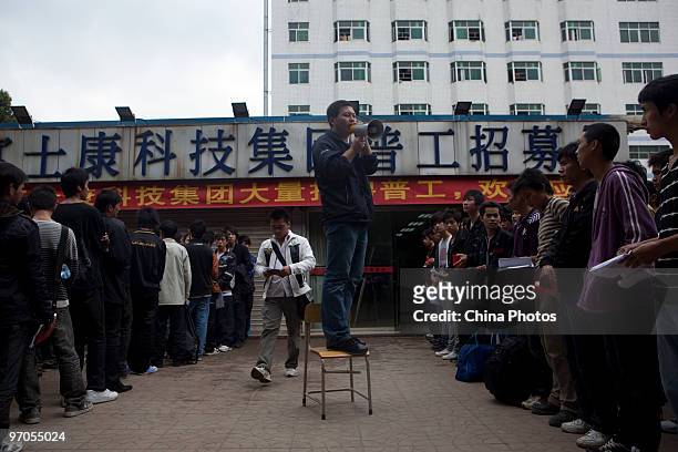 Staff member trains new migrant workers after their enrolment in the Foxconn Factory on February 24, 2010 in Shenzhen of Guangdong Province, China....