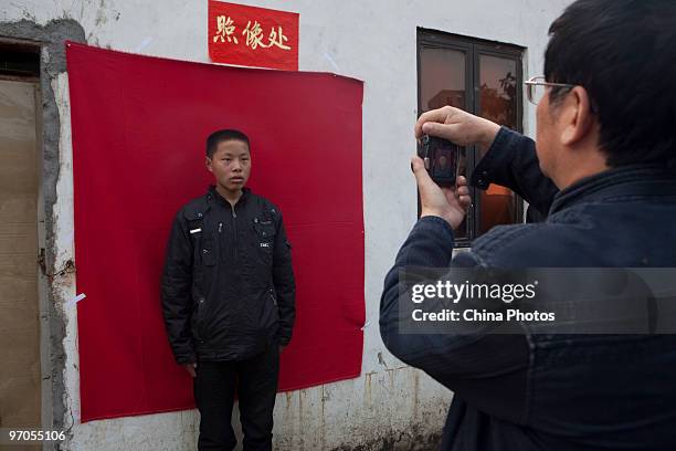 Migrant worker poses for ID photo at the Shenzhen Quanshun Human Resources Co., Ltd, on February 23, 2010 in Shenzhen of Guangdong Province, China....