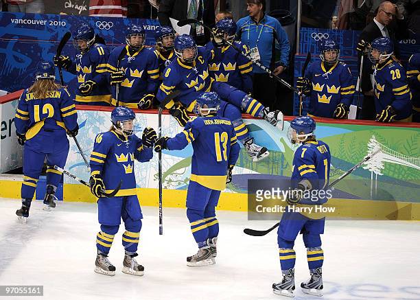 Maria Rooth of Sweden celebrates with teammates after scoring a goal during the ice hockey women's bronze medal game between Finland and Sweden on...