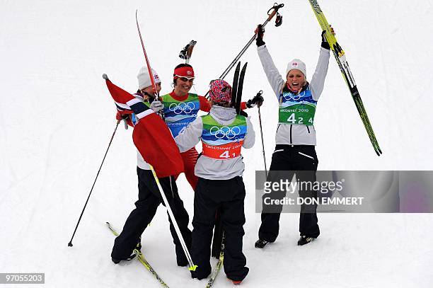 Norway's Kristin Stoemer Steira, Marit Bjoergen, Vibeke W Skofterud and Therese Johaug celebrate victory in the women's Cross Country Skiing 4x5 km...