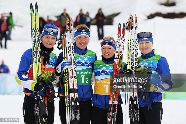 Pirjo Muranen, Virpi Kuitunen, Riitta-Liisa Roponen and Aino- Kaisa Saarinen of Finland celebrate winning the bronze medal during the Ladies' Cross...
