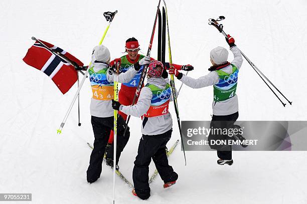 Norway's Kristin Stoemer Steira, Marit Bjoergen, Vibeke W Skofterud and Therese Johaug celebrate victory in the women's Cross Country Skiing 4x5 km...