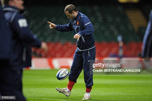 French rugby union national team's fly-half Frederic Michalak controls the ball as he takes part in a training session at the Millenium stadium in...