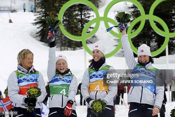 Norway's gold medalists Vibeke W Skofterud, Therese Johaug, Kristin Stoemer Steira and Marit Bjoergen stand on the podium after the women's Cross...