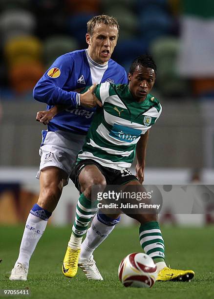 Yannick Djalo of Sporting holds off Phil Neville of Everton during the UEFA Europa League Round of 32, 2nd leg match between Sporting Lisbon and...