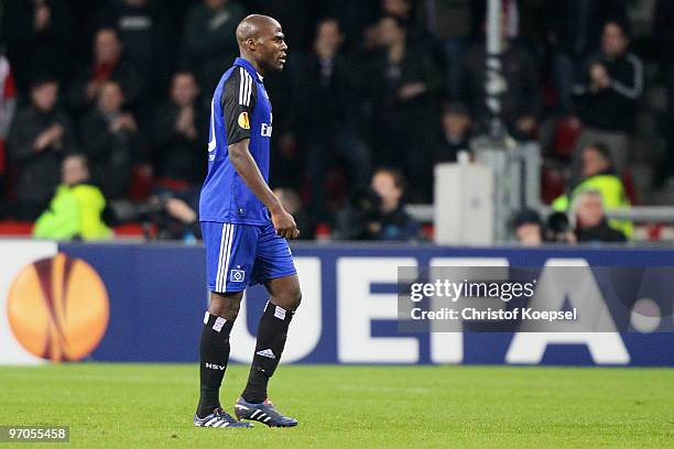 Guy Demel of Hamburg walks off the pitch after getting a yellow red card during the UEFA Europa League knock-out round, first leg match between PSV...