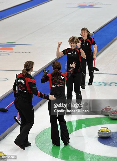 Carolyn Darbyshire of Canada clenches her fists as she celebrates with her teammates Susan O'Connor , skip Cheryl Bernard and Cori Bartel at the end...
