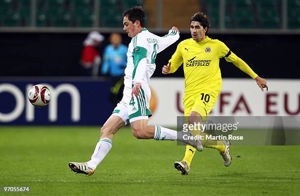 Marcel Schaefer of Wolfsburg and Cani of Villareal compete for the ball during the UEFA Europa League knock-out round, second leg match between VfL...