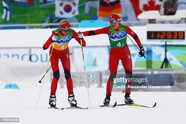 Therese Johaug of Norway hands over to Kristin Stoermer Steira during the Ladies' Cross Country 4x5 km Relay on day 14 of the 2010 Vancouver Winter...