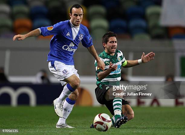 Joao Moutinho of Sporting battles with Landon Donovan of Everton during the UEFA Europa League Round of 32, 2nd leg match between Sporting Lisbon and...