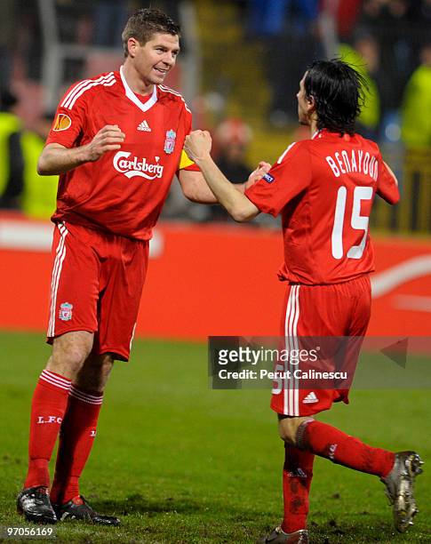 Steven Gerrard celebrates with Yossi Benayoun of Liverpool at the end of the UEFA Europa League Round of 32, 2nd leg match between FC Unirea Urziceni...