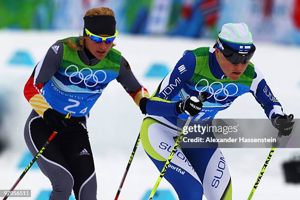 Aino- Kaisa Saarinen of Finland competes with Claudia Nystad of Germany during the Ladies' Cross Country 4x5 km Relay on day 14 of the 2010 Vancouver...