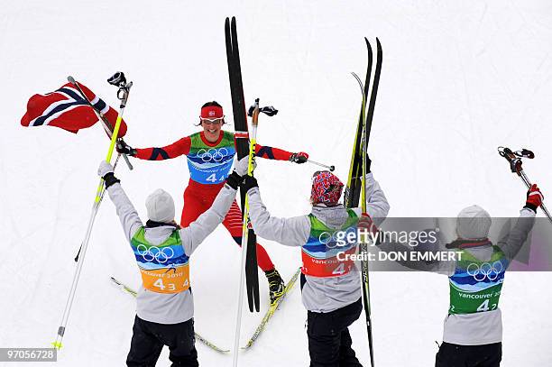 Norway's Marit Bjoergen celebrates with teammates Kristin Stoemer Steira , Vibeke W Skofterud and Therese Johaug after the women's Cross Country...