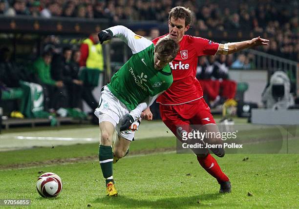 Marko Marin of Bremen and Wout Brama of Twente battle for the ball during the UEFA Europa League knock-out round, second leg match between SV Werder...